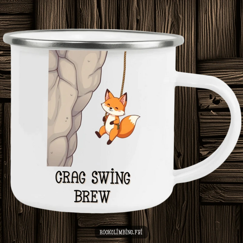 Funny Fox Camping Mug: A playful fox dangles from a rope swing on a tall crag, perfect for rugged, fun enjoyment.