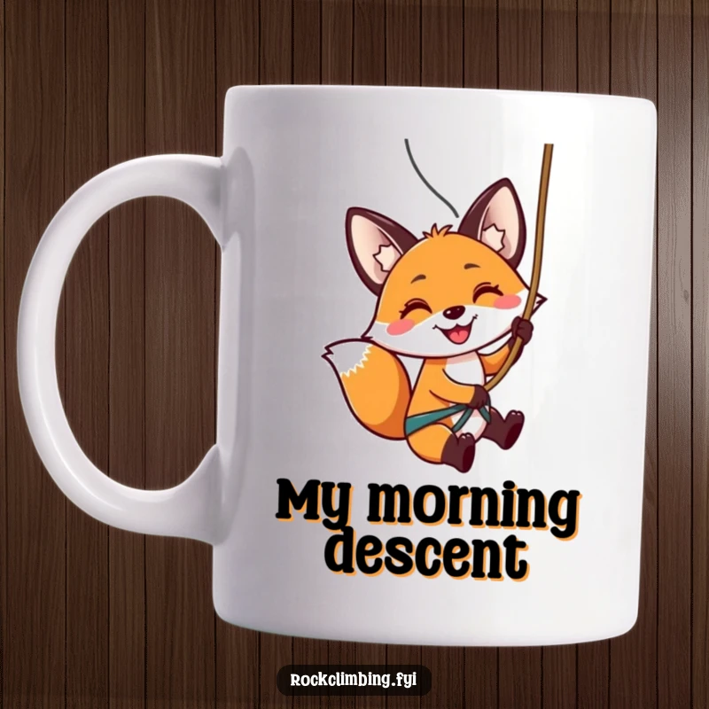Funny mug featuring a smiling fox expertly rappelling down a rocky cliff face using a rope with enthusiasm.