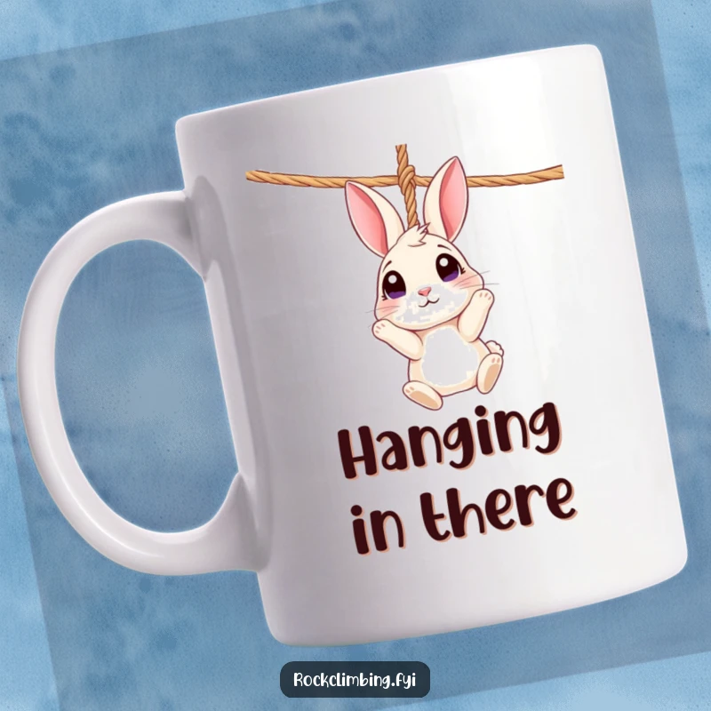 Funny Rabbit Rope Mug: A curious rabbit dangles from a rope, looking up with wide eyes, whimsical gift.