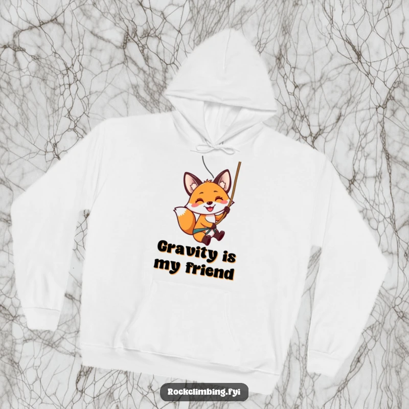 Funny hoodie showing a smiling fox rappelling down a steep rock face, embodying adventurous and humorous spirit.