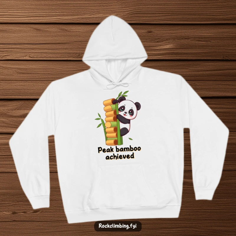 Funny panda scaling a massive bamboo tower on a cozy hoodie, symbolizing determination and providing humorous warmth.