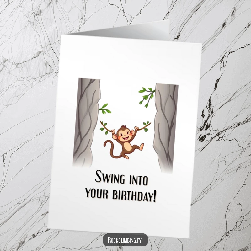 Funny Free Printable Birthday Card: A silly monkey gleefully swings on a vine between rocky peaks.