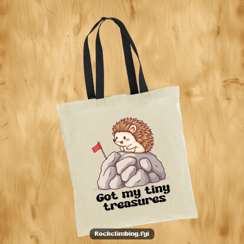 Funny tote bag featuring a happy hedgehog planting a flag on a rocky peak, symbolizing a charming and hilarious pursuit of goals.