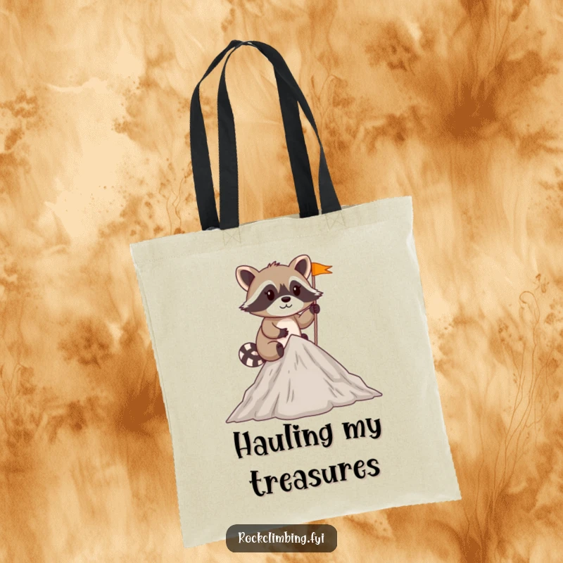 Funny mischievous raccoon planting a tiny flag at the summit of a small peak on a durable tote bag.