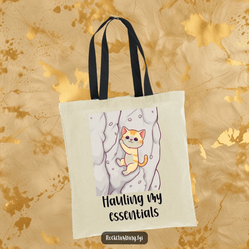 Funny cat tote bag illustrating a cat using suction cups to scale a rock face, a humorous and practical accessory.