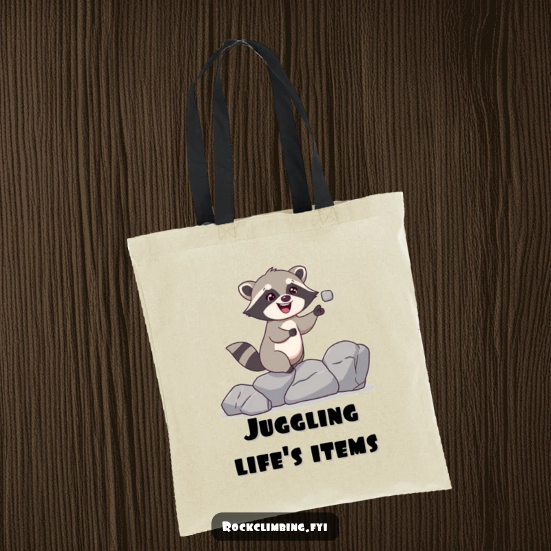 Funny raccoon tote bag featuring a giggling raccoon juggling rocks while climbing, ideal for carrying items with a humorous theme.